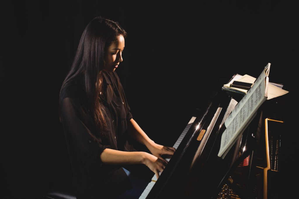 female student playing piano