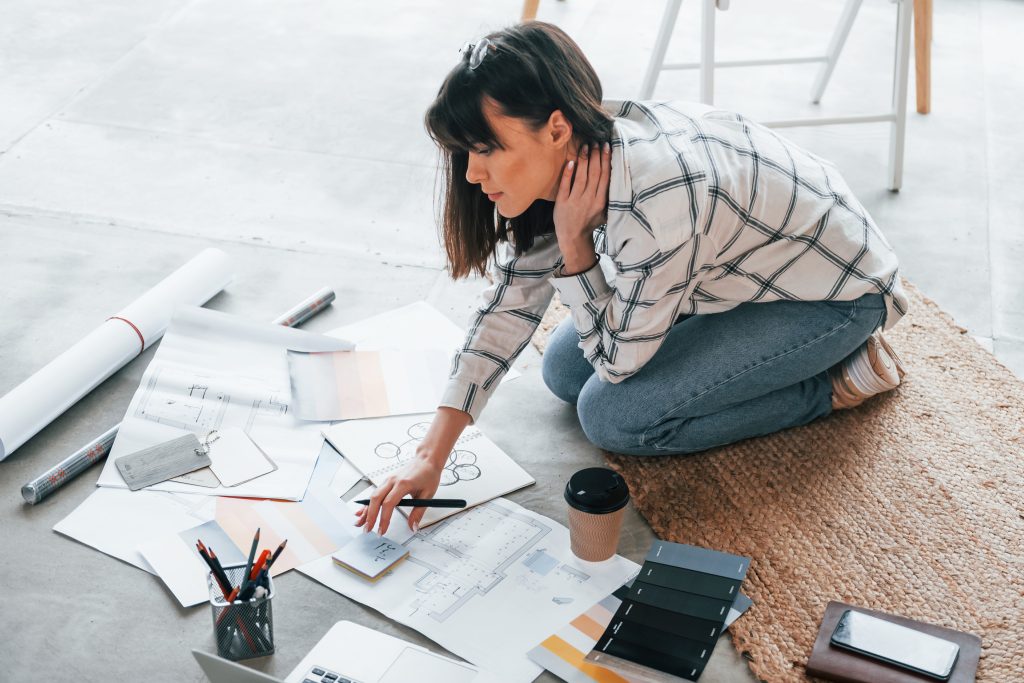 sits floor young female freelance worker is indoors home daytime